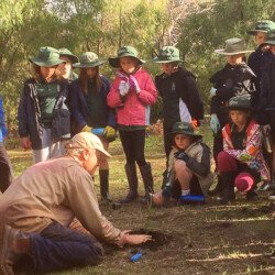 Adopt a Spot school children get planting instruction.